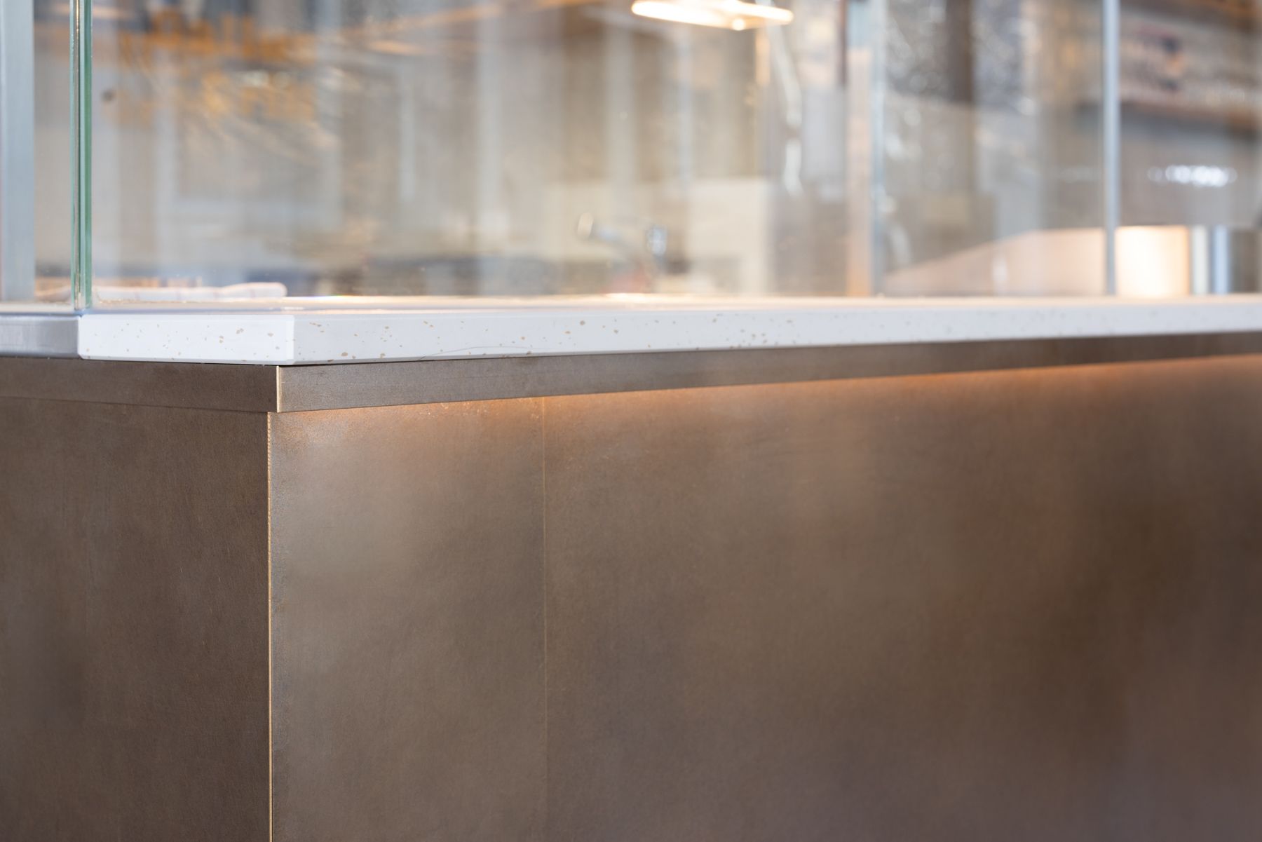 The focal point is a grand central grill clad in bronzed brass setting the stage for the down to earth eatery